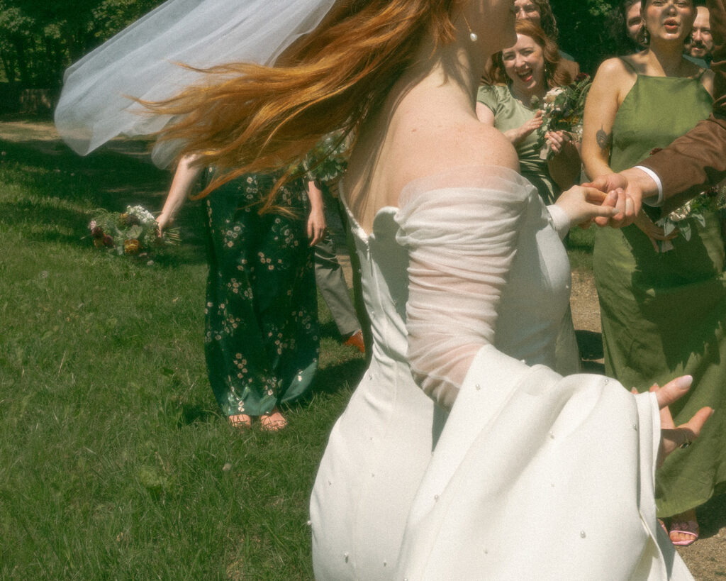 Bride and groom walking through Stony Creek Metropark in Detroit, Michigan