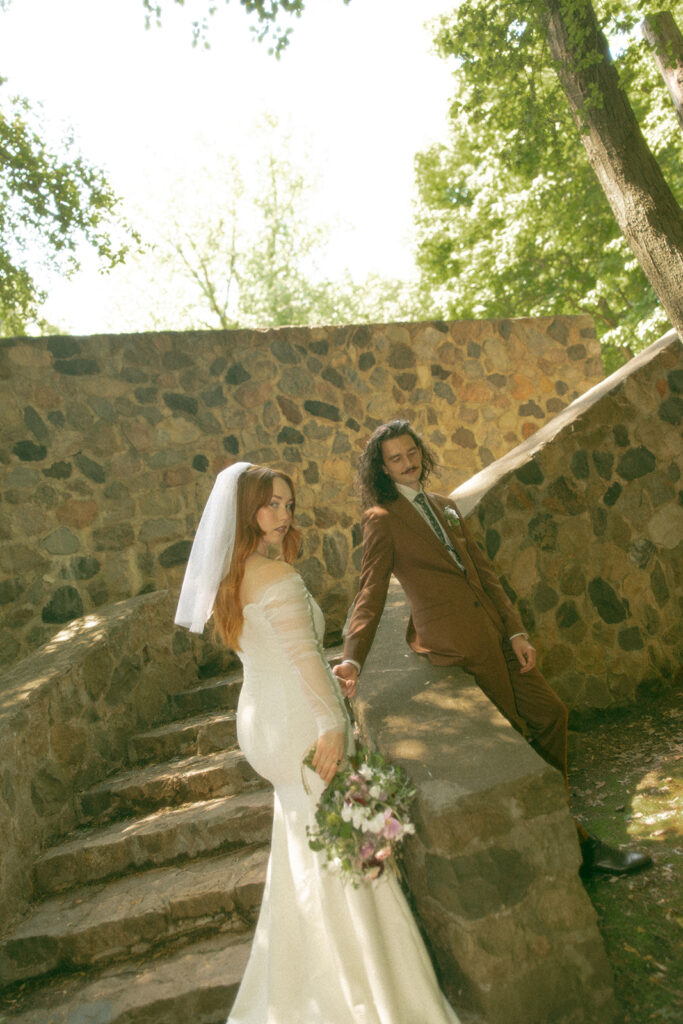 Whimsical outdoor bride and grooms portraits from their Stony Creek Metropark wedding in Detroit, Michigan