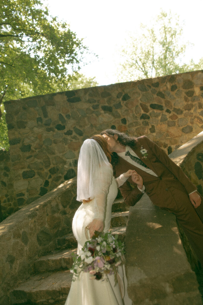 Whimsical outdoor bride and grooms portraits from their Stony Creek Metropark wedding in Detroit, Michigan