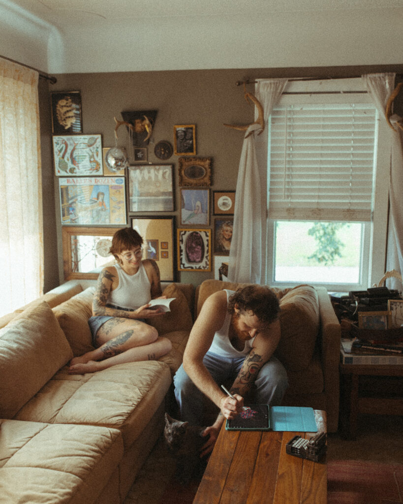 Man playing games while woman reads on the couch