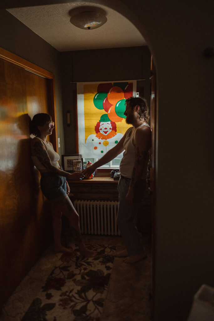 Man and woman posing for their at-home Grand Rapids engagement photos