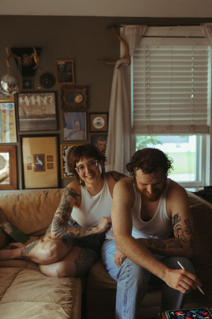 Man and woman holding hands during their at-home Grand Rapids engagement photos