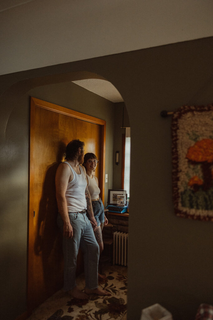 Man and woman posing for their at-home Grand Rapids engagement photos