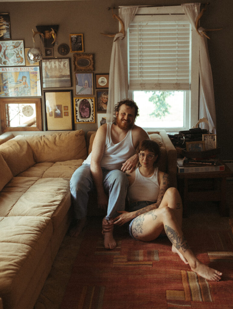 Couple sitting in their living room during their at-home couples photoshoot in Michigan