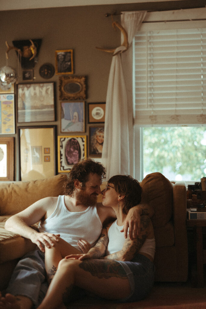 Man and woman touching noses during their at-home couples photoshoot in Grand Rapids, Michigan