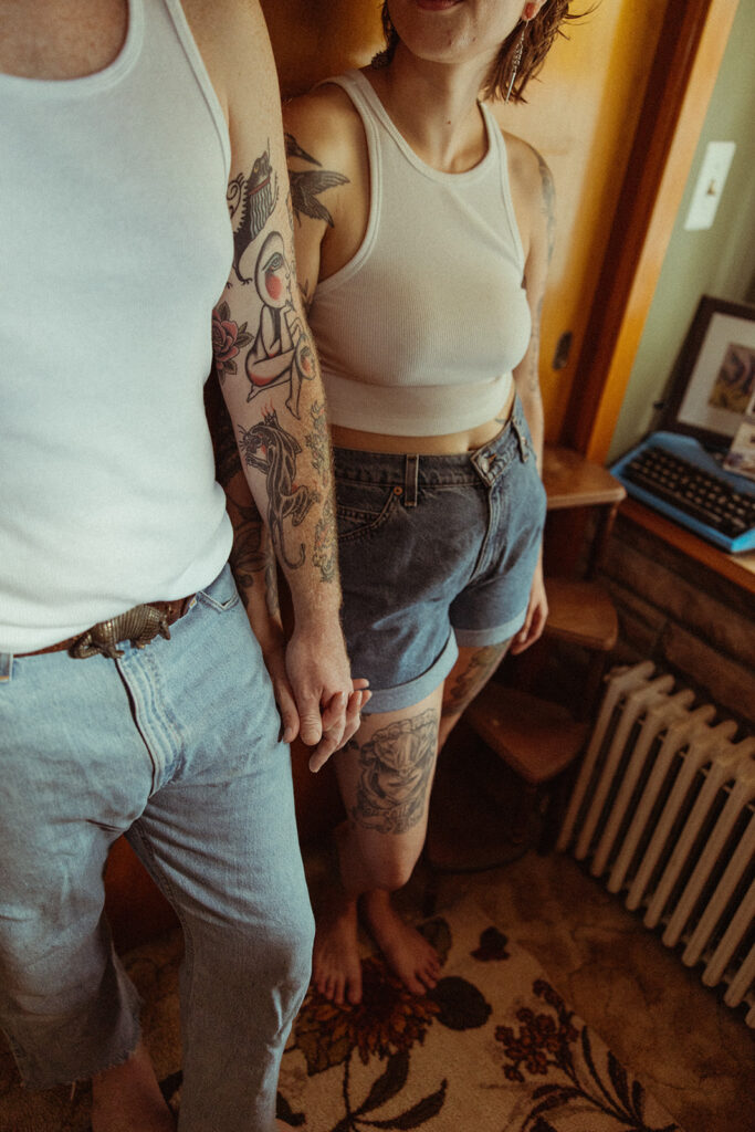 Couple holding hands during their at-home couples photoshoot in Michigan