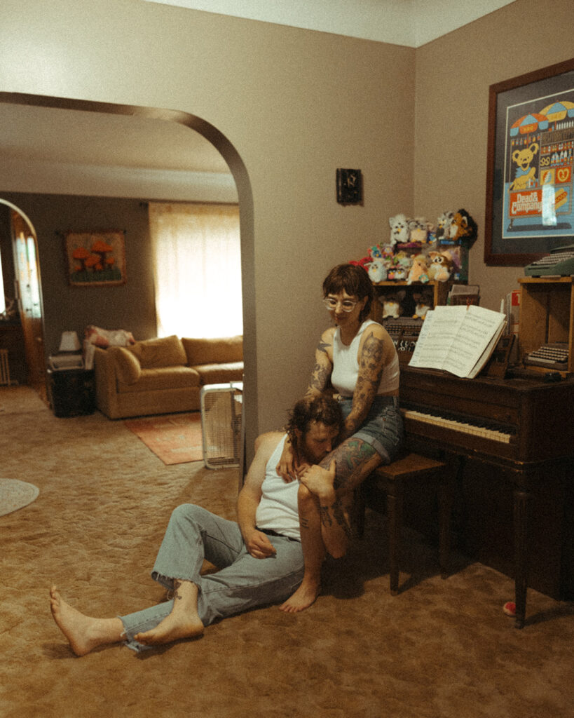 Couple sitting at their piano during their at-home couples photoshoot