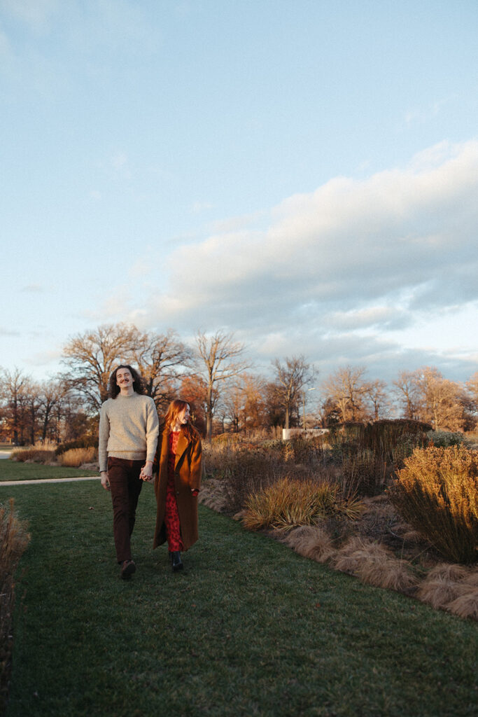 Man and woman walking together during their Belle Isle engagement photos in Detroit, Michigan