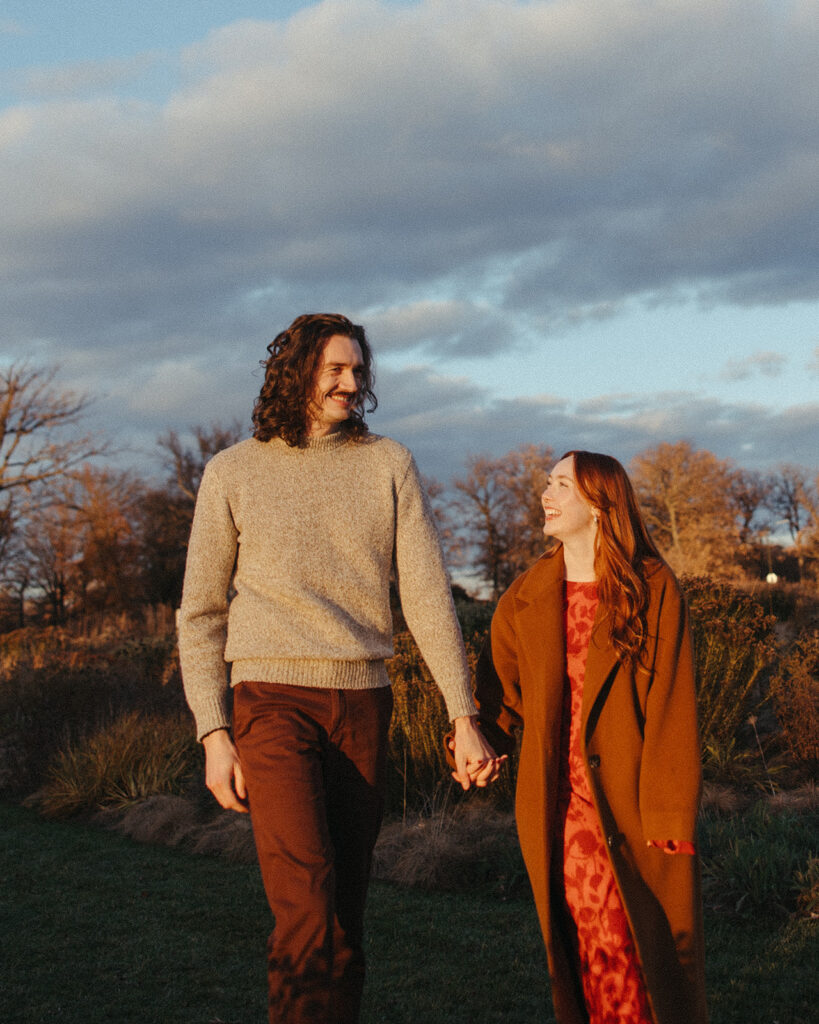 Man and woman walking together during their Belle Isle engagement photos in Detroit, Michigan