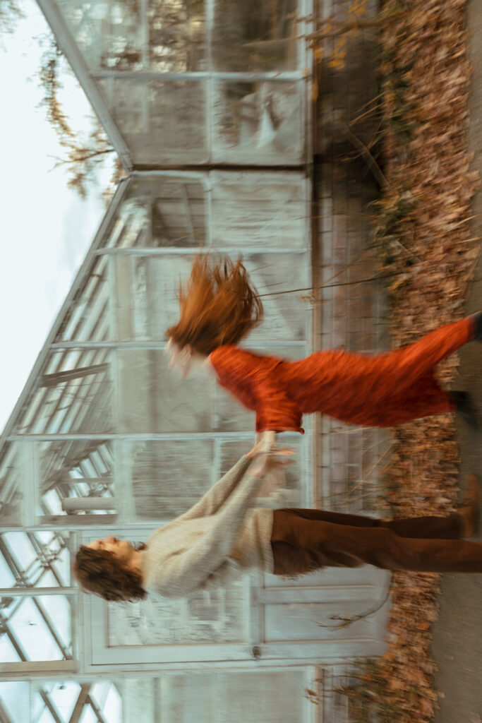 Couple being playful during their Belle Isle engagement photos in Detroit, Michigan