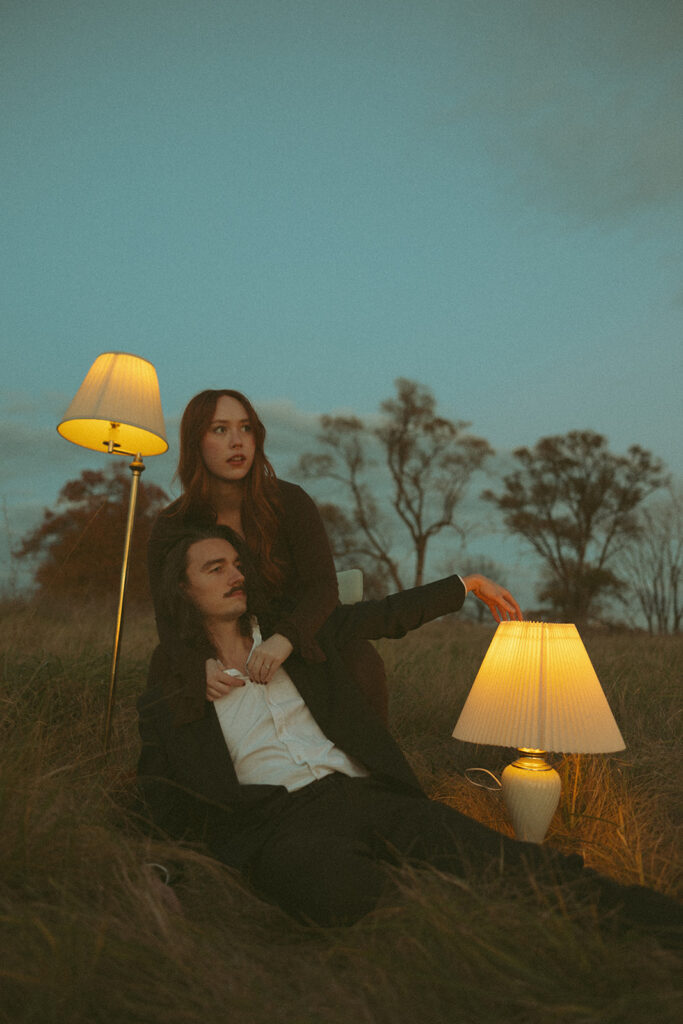 Couple posing for photos in an open field in Detroit, Michigan