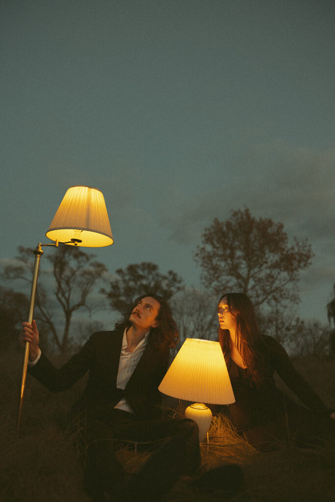 Couple posing with lampshades during their fall engagement shoot in Detroit, Michigan