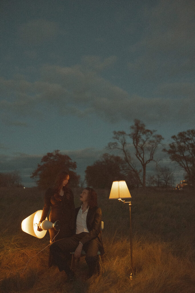 Couple standing in an open field during their outdoor fall engagement photos