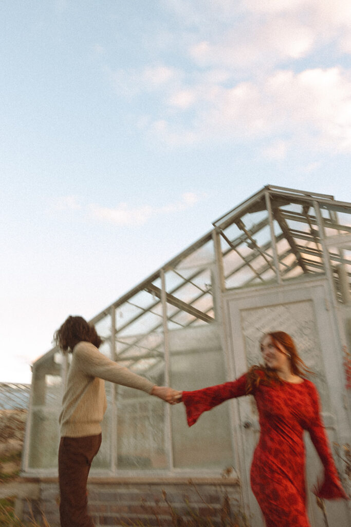 Man and woman holding hands during their Belle Isle engagement photos in Detroit, Michigan