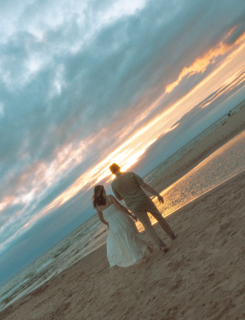 Couples sunset Lake Michigan engagement photos at Duck Lake State Park in Muskegon