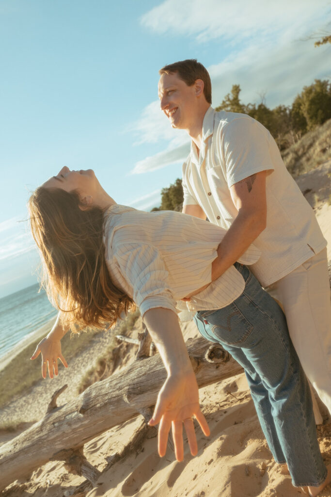 Man and woman being playful during their engagement shoot