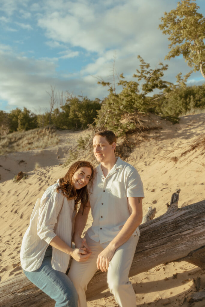 Man and woman sitting on a beach log