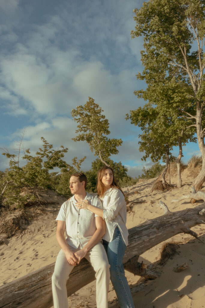 Man and woman posing for their Lake Michigan engagement photos