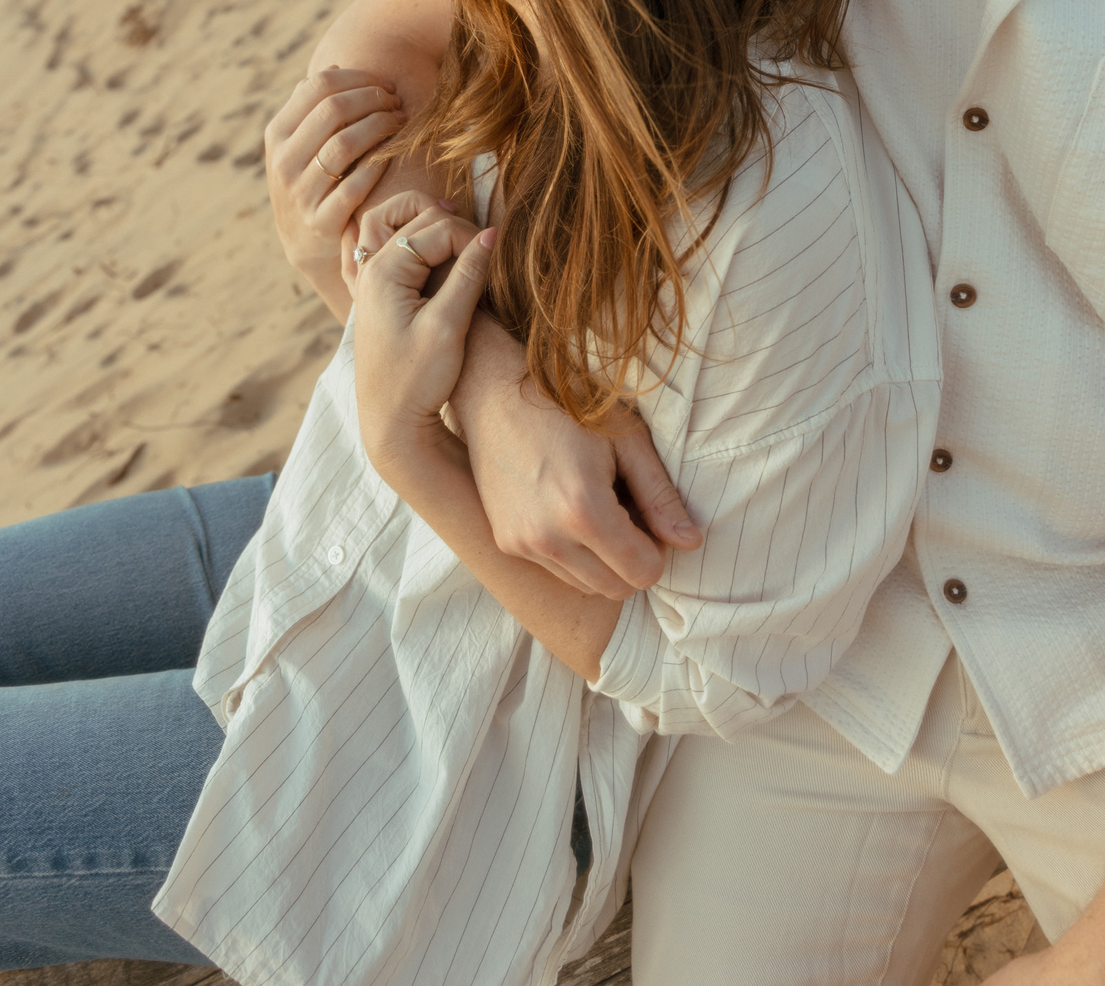 Close up shot of a man and woman sitting on the beach together