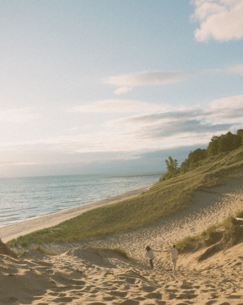 Couple walking along the beach at Duck Lake State Park in Muskegon