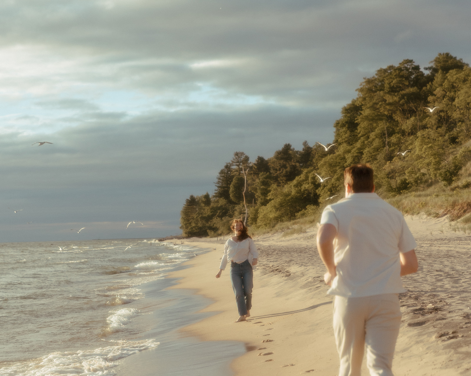 Couples Lake Michigan beach engagement photos at Duck Lake State Park in Muskegon