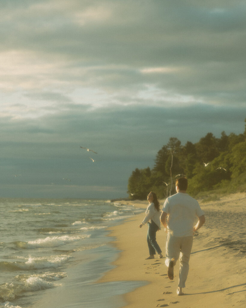 Couple walking the Lake Michigan shoreline at Duck Lake State Park in Muskegon