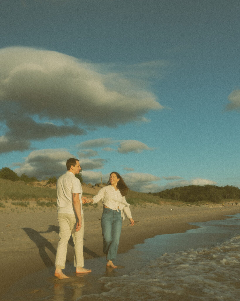 Couple walking the shoreline at Duck Lake State Park in Muskegon, Michigan