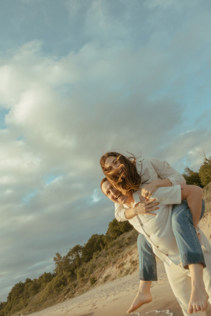 Man giving his fiancé a piggy back ride