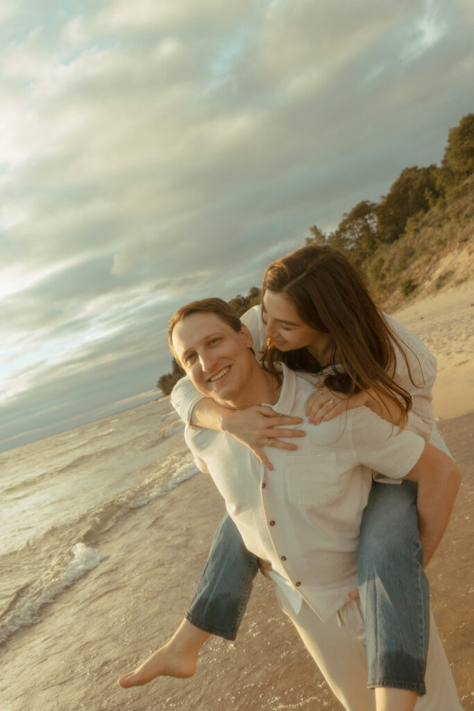 Man giving his fiancé a piggy back ride