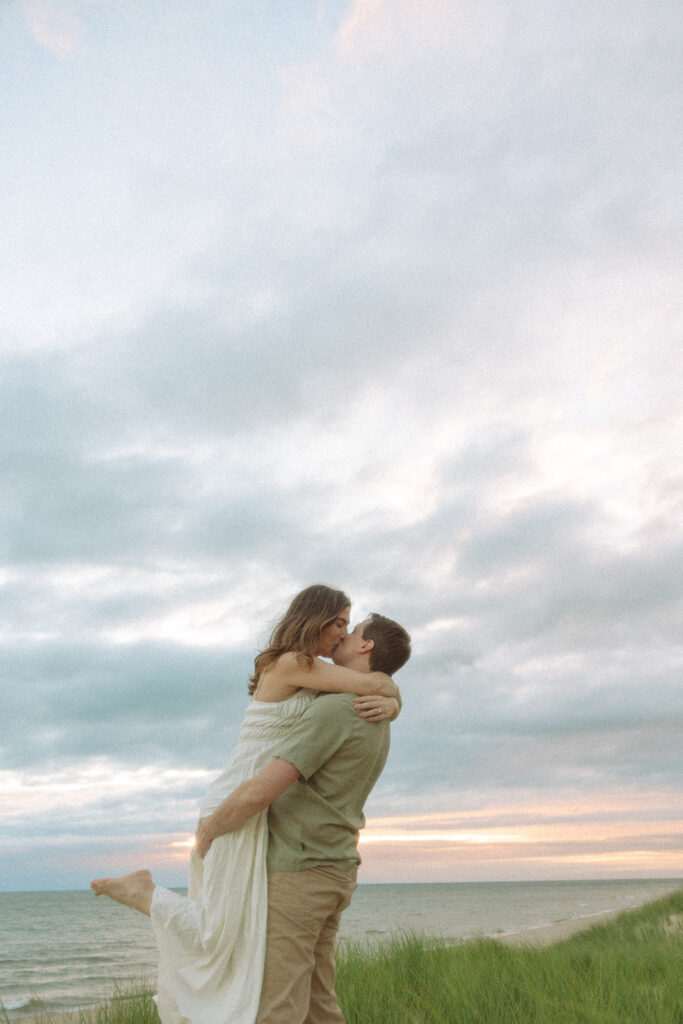 Couple kissing on the beach at at Duck Lake State Park in Muskegon