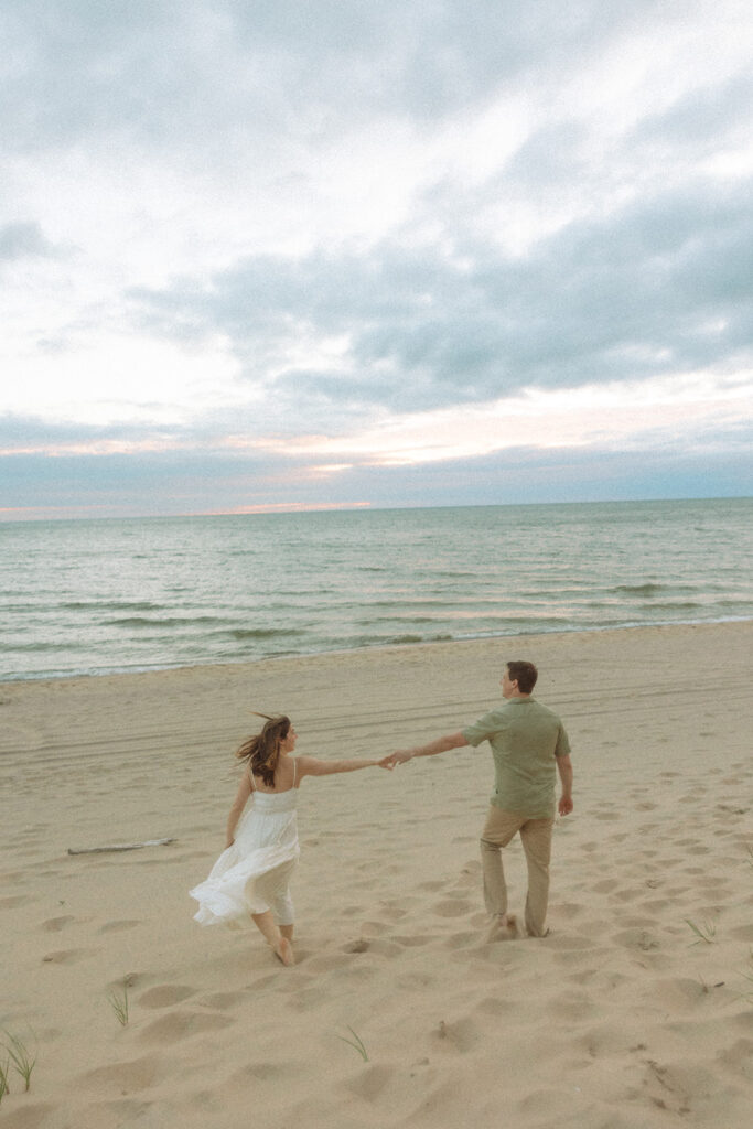 Couple holding hands at at Duck Lake State Park in Muskegon