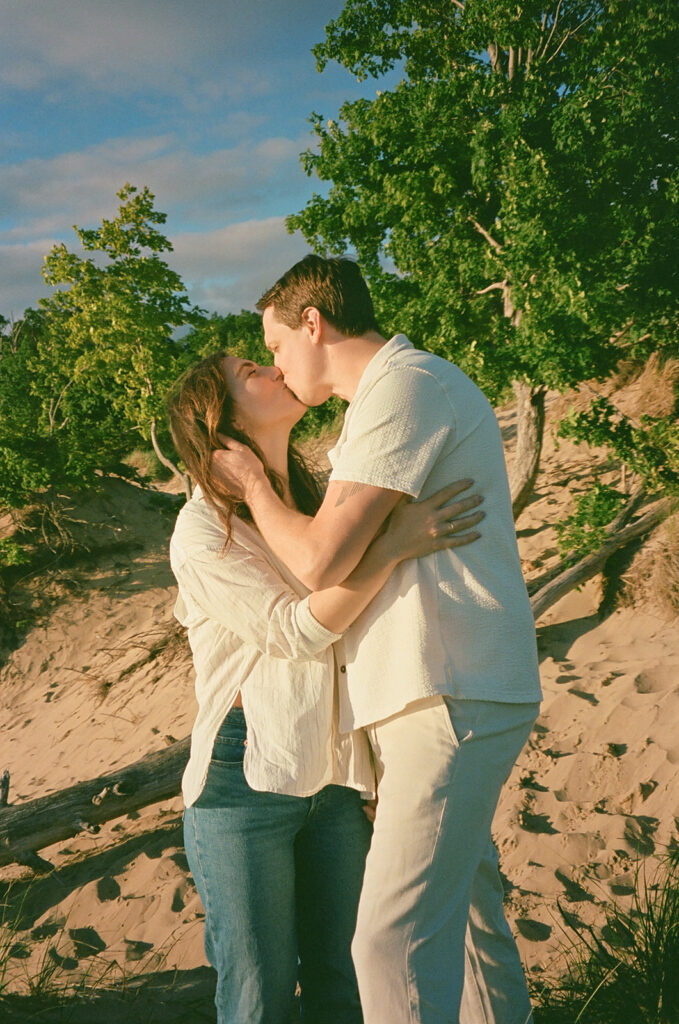 Couple kissing during their beach engagement session