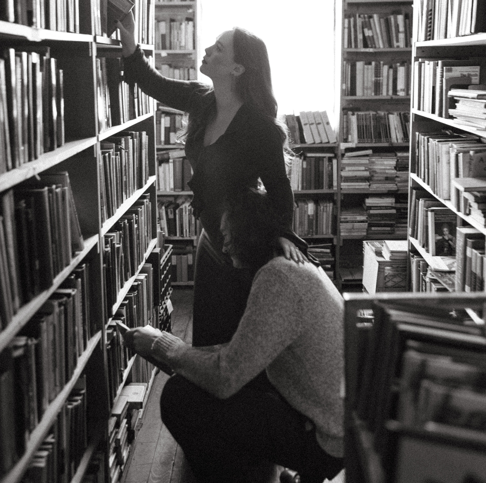 Black and white photo of a couple at John K King Books in Detroit, Michigan for their engagement session