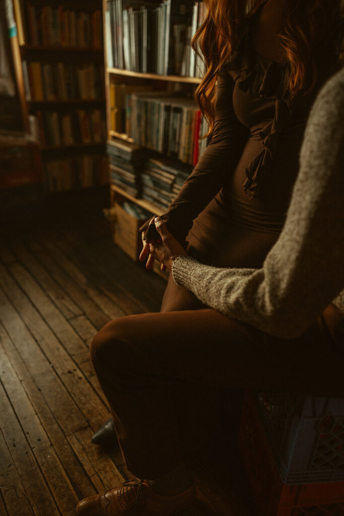 Photo of a couple holding hands during their bookstore engagement session