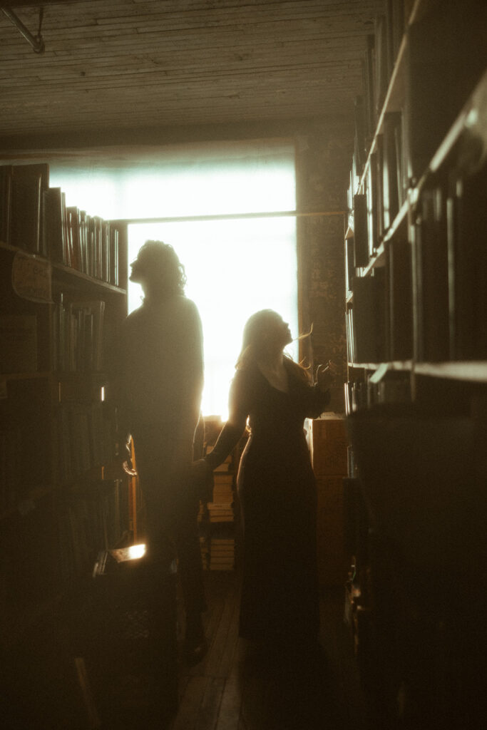 Couples romantic bookstore engagement session at John K King Books in Detroit, Michigan