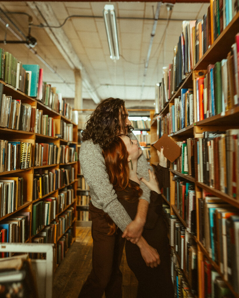 Couple at John K King Books in Detroit, Michigan for their engagement session