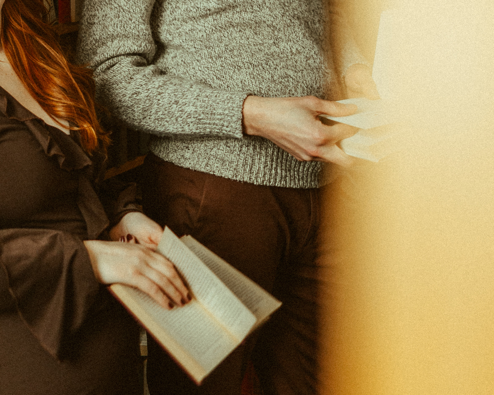 Close up shot of a couple reading books together during their bookstore engagement session in Detroit, Michigan