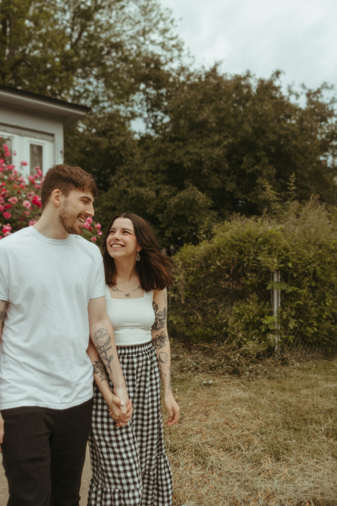 Couple holding hands during their summer engagement session