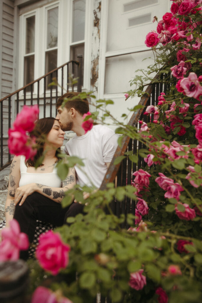 Man kissing his fiancés head during their Bay City engagement photos