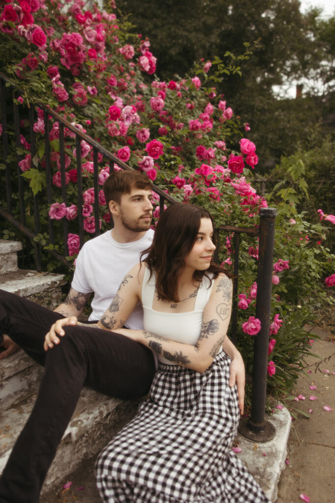 Couple sitting on stairs during their Bay City engagement photos in Michigan