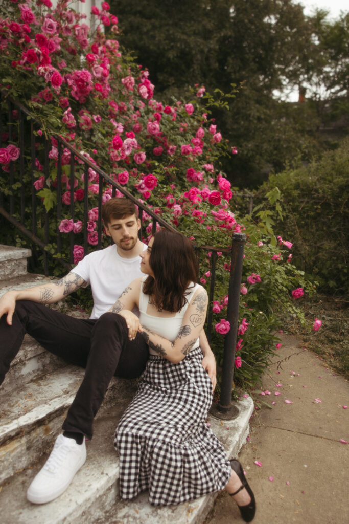 Couple sitting on stairs during their Bay City engagement photos in Michigan