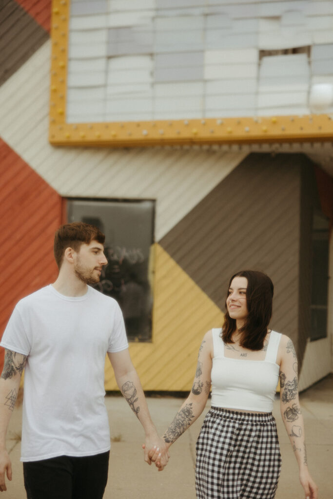 Couple holding hands and walking in downtown Bay City, Michigan