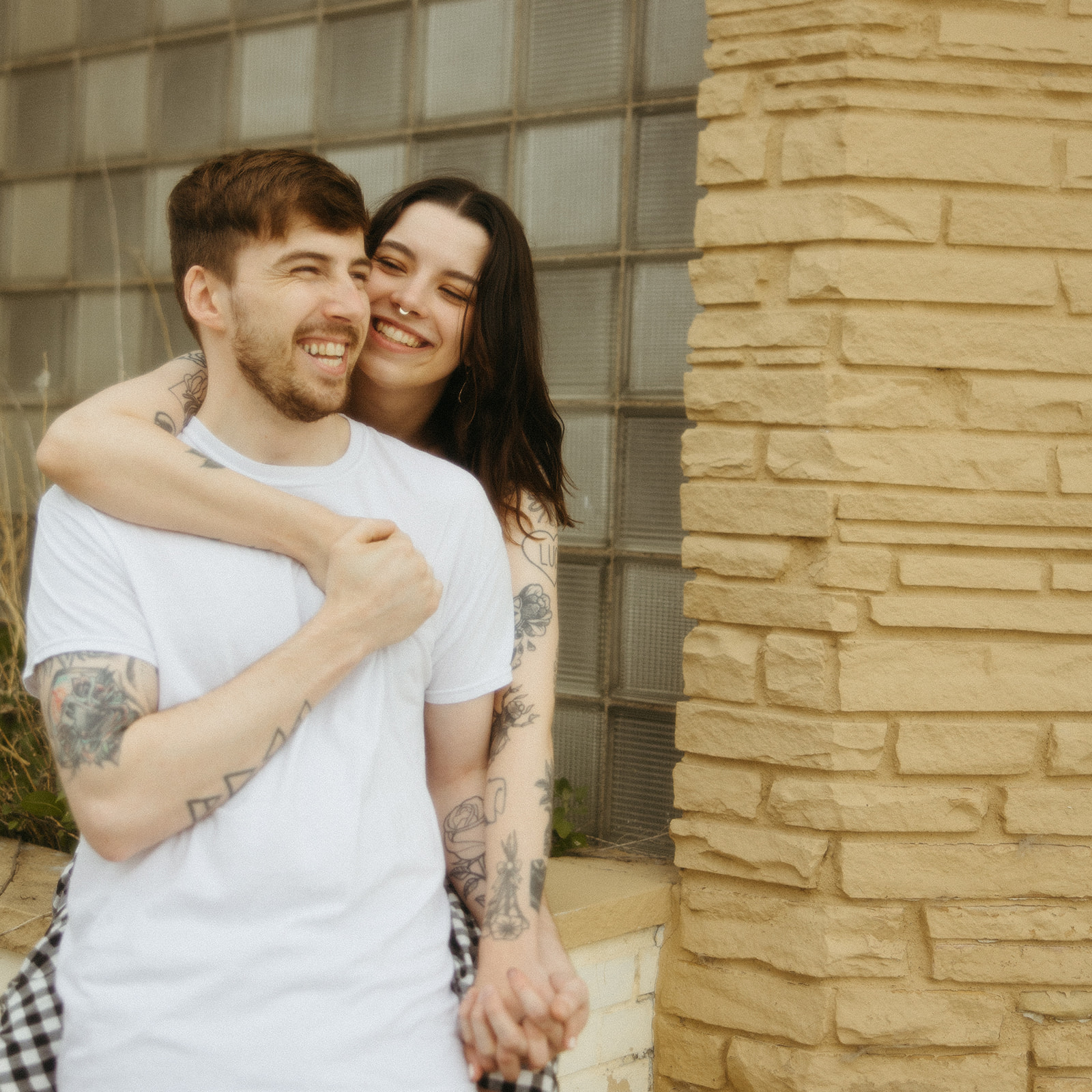 Couple laughing together during their downtown Bay City engagement photos