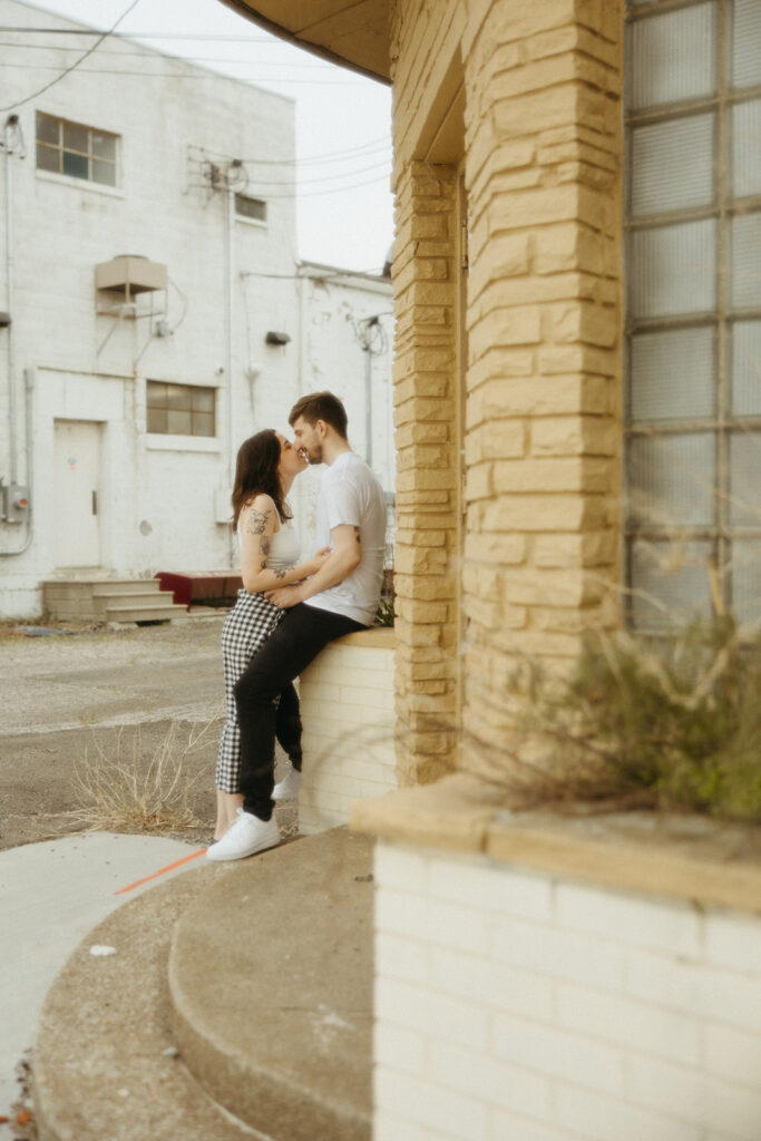 Couple kissing during their downtown engagement photos in Bay City, Michigan