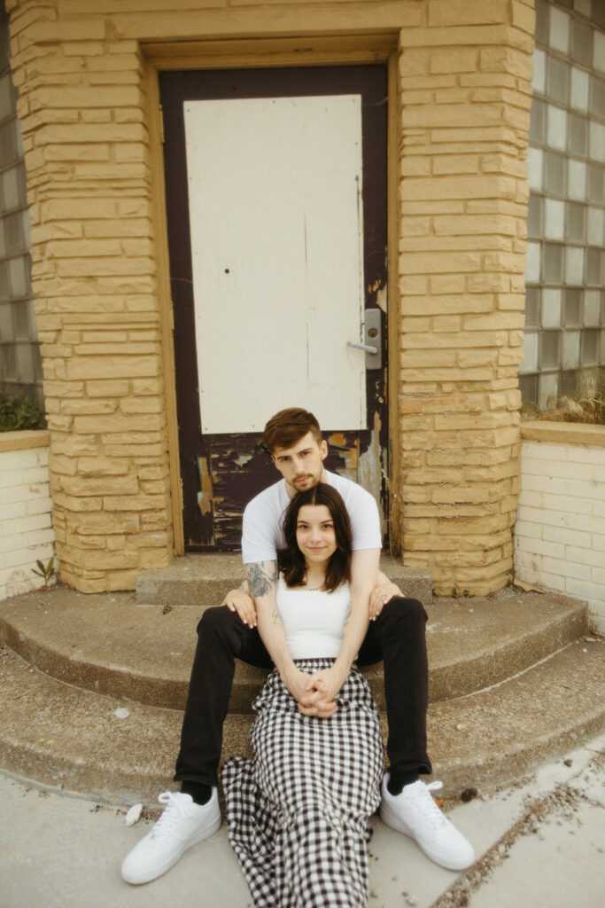 Man and woman posing for their downtown Bay City engagement photos