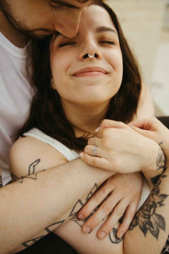 Man and woman holding each other during their engagement shoot