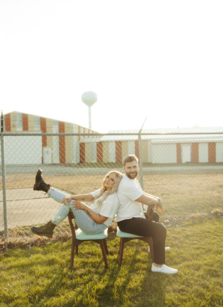 Couple sitting in chairs outside for their engagement photos in Detroit, Michigan