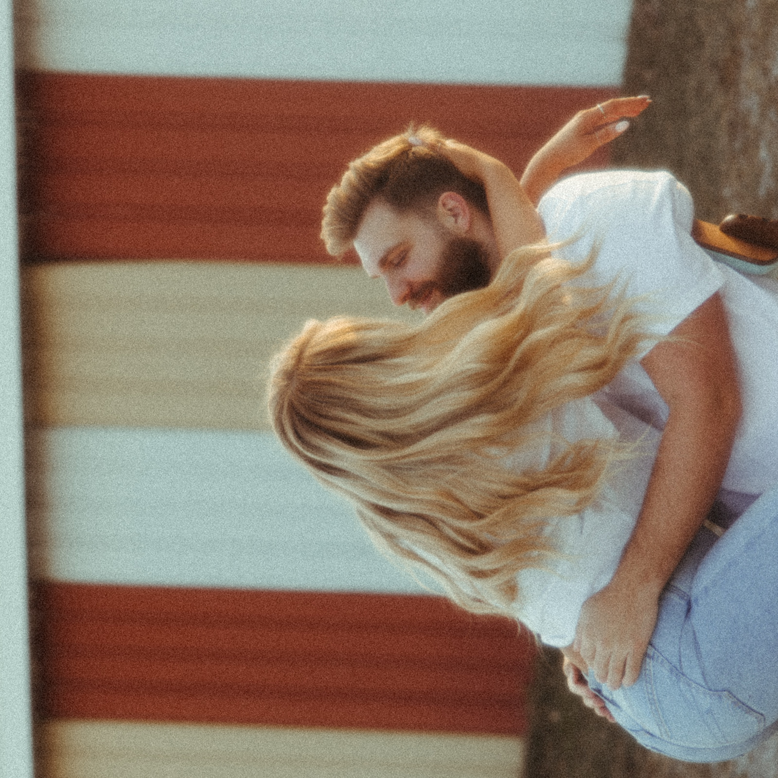 Woman straddling her fiancé in a chair during their Midwest engagement shoot