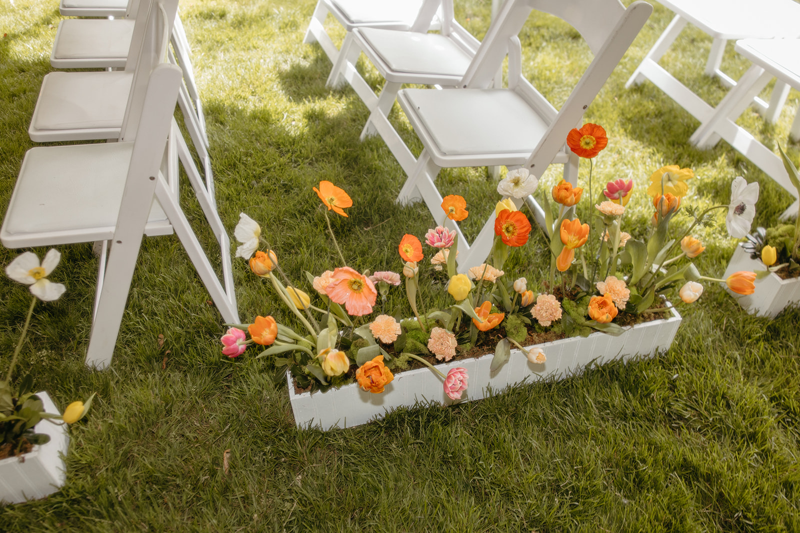 Flower boxes lining the aisle of a backyard Ann Arbor wedding ceremony