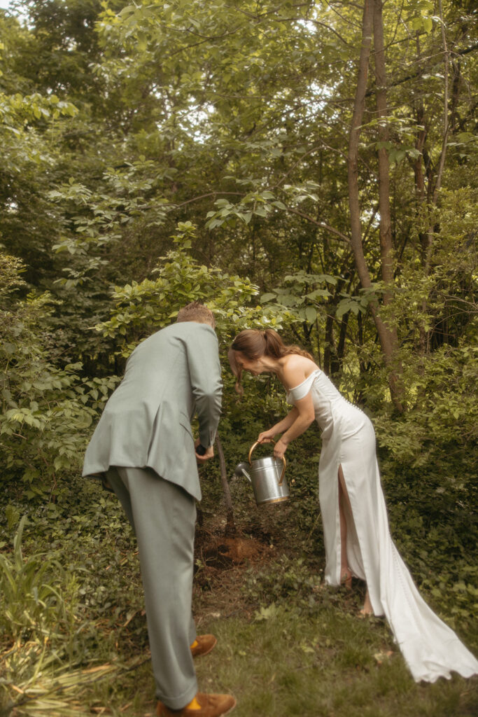 Bride and groom doing a tree planting ceremony during their backyard Ann Arbor wedding ceremony